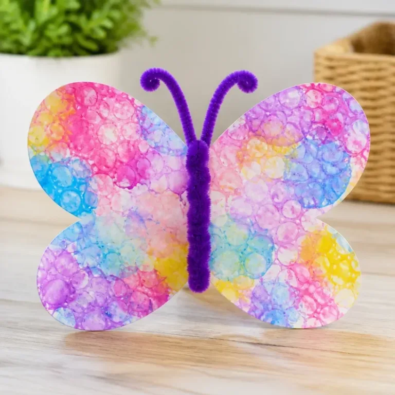 Colorful DIY bubble print butterfly wings craft for kids activity.