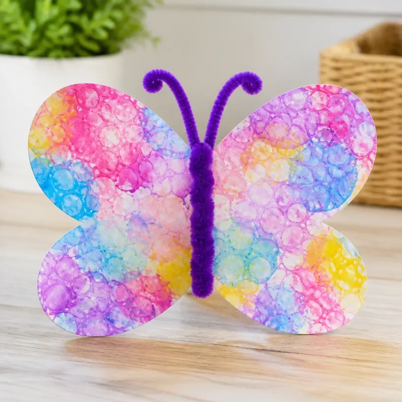 Colorful DIY bubble print butterfly wings craft for kids activity.